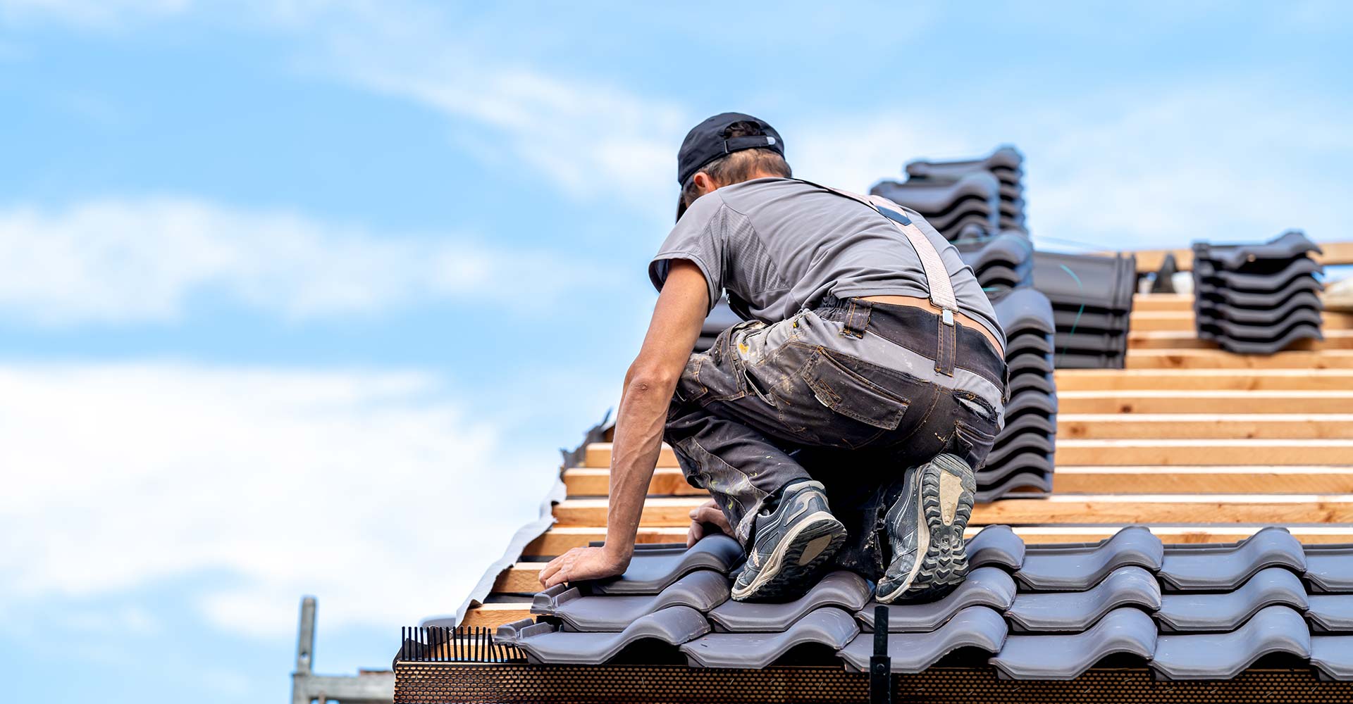 Roofer working on new roof installation
